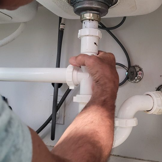 handyman-at-home-tightening-seals-on-plumbing-pipe